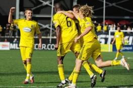 Crew soccer players wearing yellow