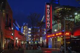 Columbus Gateway district at night with neon signs and lit up buildings