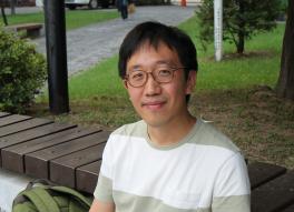 June Huh on outdoor bench