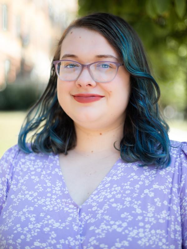Lily in lilac dress and glasses
