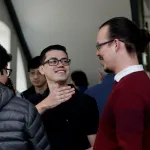 faculty and students talking