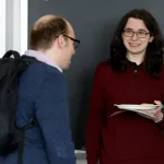 student and faculty talking