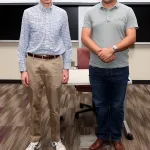 Professor and student taking photo