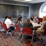 Students gathering around table
