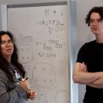 People standing in front of white board