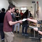 Tracy Braund handing brochure to student