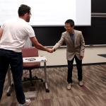 Student and professor shaking hands